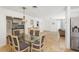Open concept dining area, featuring stone flooring and open floor plan at 1309 Nokomis S Ave, Venice, FL 34285