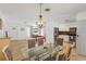 Bright dining area, with stone flooring, chandelier, and adjacent kitchen at 1309 Nokomis S Ave, Venice, FL 34285