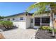 Well-maintained single-story home showcasing a paved walkway, a tidy garden, and a screened lanai at 1309 Nokomis S Ave, Venice, FL 34285