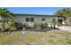 Charming single-story home with manicured landscaping, lush greenery, and a well-maintained lawn at 1309 Nokomis S Ave, Venice, FL 34285