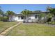 Charming single-story home with tropical landscaping and a well-kept lawn at 1309 Nokomis S Ave, Venice, FL 34285