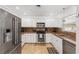 Well-lit kitchen with stainless steel appliances and granite countertops at 1309 Nokomis S Ave, Venice, FL 34285