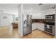 Bright kitchen features white cabinets, stainless steel appliances, and granite countertops at 1309 Nokomis S Ave, Venice, FL 34285