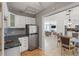 The kitchenette is equipped with white cabinets and a stainless steel refrigerator at 1309 Nokomis S Ave, Venice, FL 34285