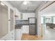Cozy kitchenette with stainless steel refrigerator and white cabinets at 1309 Nokomis S Ave, Venice, FL 34285