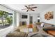 Cozy living room featuring comfortable seating, a ceiling fan, and a bright window at 1309 Nokomis S Ave, Venice, FL 34285