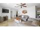 Bright living room with comfortable sofas, tile flooring, and a view into the bedroom at 1309 Nokomis S Ave, Venice, FL 34285
