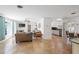 Bright living room boasts stone flooring, ceiling fan, and ample natural light at 1309 Nokomis S Ave, Venice, FL 34285