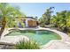 Backyard pool with lush landscaping, outdoor shower, and sunny skies at 1309 Nokomis S Ave, Venice, FL 34285