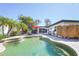 Lush backyard with a beautiful pool, outdoor shower, and comfortable seating at 1309 Nokomis S Ave, Venice, FL 34285