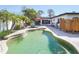 Beautiful backyard pool with an outdoor shower and lush landscaping at 1309 Nokomis S Ave, Venice, FL 34285