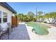 Inviting pool area with lush tropical landscaping and a convenient outdoor shower at 1309 Nokomis S Ave, Venice, FL 34285