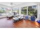 Bright and airy sunroom with tile floors, large windows, and comfortable seating at 1309 Nokomis S Ave, Venice, FL 34285