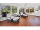 Bright and airy sunroom with tile floors, large windows, and comfortable seating at 1309 Nokomis S Ave, Venice, FL 34285