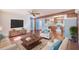 Bright living room with hardwood floors, comfortable seating, and an open floor plan into the kitchen at 21 Belle Meade Cir, Largo, FL 33770