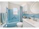 Retro bathroom with blue tile and updated fixtures at 5006 Springwood N Ave # 119, Pinellas Park, FL 33782