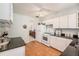 Bright eat-in kitchen features granite counters, white cabinets and appliances at 5006 Springwood N Ave # 119, Pinellas Park, FL 33782