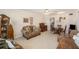 Inviting living room features carpet flooring, comfortable seating, and traditional furnishings at 5006 Springwood N Ave # 119, Pinellas Park, FL 33782