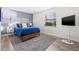Well-lit bedroom with gray rug, accent wall, flat screen TV and large window at 6265 Sun Blvd # 101, St Petersburg, FL 33715