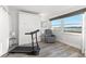 Bright bedroom with a murphy bed, treadmill and serene water views at 6265 Sun Blvd # 101, St Petersburg, FL 33715