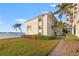 Waterfront building with lush landscaping and palm trees at 6265 Sun Blvd # 101, St Petersburg, FL 33715