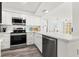 Contemporary kitchen with stainless steel appliances and white cabinetry at 6265 Sun Blvd # 101, St Petersburg, FL 33715