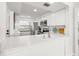 Bright kitchen features white cabinets, stainless steel appliances, and solid surface counters at 6265 Sun Blvd # 101, St Petersburg, FL 33715