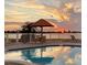 Inviting community pool area overlooking the water at sunset at 6265 Sun Blvd # 101, St Petersburg, FL 33715