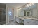 Elegant bathroom features double vanities, granite countertops, and a glass-enclosed shower at 8044 Lago Mist Way, Wesley Chapel, FL 33545