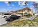 Inviting condo building with balcony access, attractive landscaping, and assigned parking spaces at 9945 47Th N Ave # 206, St Petersburg, FL 33708