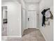 Inviting entryway with tiled flooring, a coat rack, and a view into the living space at 10511 Fuzzy Cattail St, Riverview, FL 33578