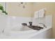 A relaxing tub with brown caddy and shelf decor at 1115 Andrew Aviles Cir, Tampa, FL 33619