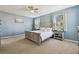 Comfortable bedroom featuring a ceiling fan, soft carpet, and two windows with natural light at 1115 Andrew Aviles Cir, Tampa, FL 33619