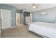 Bedroom includes carpet, ceiling fan, an open door to the en-suite bathroom, and a dresser at 1115 Andrew Aviles Cir, Tampa, FL 33619