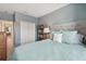 Bedroom featuring a queen-sized bed with a tufted headboard and pastel blue bedding at 1115 Andrew Aviles Cir, Tampa, FL 33619