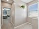 Hallway with a plant decoration and a bedroom in the background at 1115 Andrew Aviles Cir, Tampa, FL 33619