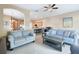 Living Room showcasing an open floorplan into the dining room and kitchen with updated floors at 1115 Andrew Aviles Cir, Tampa, FL 33619