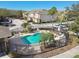 Community pool with a black metal fence surrounded by palm trees and lounge chairs on the pool deck at 1115 Andrew Aviles Cir, Tampa, FL 33619