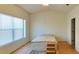 Light-filled bedroom with a queen-size bed, wooden floors, and bright natural light at 1275 Drew St, Clearwater, FL 33755