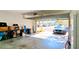 Open garage with a car and storage space, leading to a residential street view at 1275 Drew St, Clearwater, FL 33755