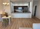 Bright open kitchen features granite countertops, modern appliances, and an adjacent dining area at 1275 Drew St, Clearwater, FL 33755