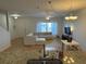 Open-concept living room with a large sectional, modern entertainment center, and an adjacent kitchen at 1275 Drew St, Clearwater, FL 33755