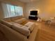 Cozy living room featuring a large sectional, entertainment center, and bright natural lighting at 1275 Drew St, Clearwater, FL 33755