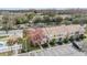 Aerial view of colorful townhome community with ample parking and mature landscaping at 1308 Costa Mesa Dr, Wesley Chapel, FL 33543