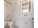 Bathroom featuring white vanity with brushed nickel fixtures and tiled bath with shower at 1308 Costa Mesa Dr, Wesley Chapel, FL 33543
