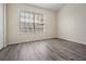 A small bedroom with laminate flooring and a window with blinds at 1308 Costa Mesa Dr, Wesley Chapel, FL 33543