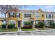 Charming townhome with colorful facade, well-maintained landscaping, and dedicated parking spaces at 1308 Costa Mesa Dr, Wesley Chapel, FL 33543