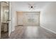 Bright living room with wood floors, ceiling fan, and natural light from the window at 1308 Costa Mesa Dr, Wesley Chapel, FL 33543