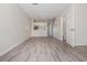Open living room with dining area and wood-look flooring, leading to stairs and bathroom at 1308 Costa Mesa Dr, Wesley Chapel, FL 33543