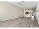 Open living space with wood-look floors and a view to the kitchen at 1308 Costa Mesa Dr, Wesley Chapel, FL 33543